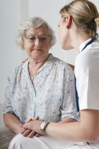 senior woman going through stress and trauma receiving care from a nurse