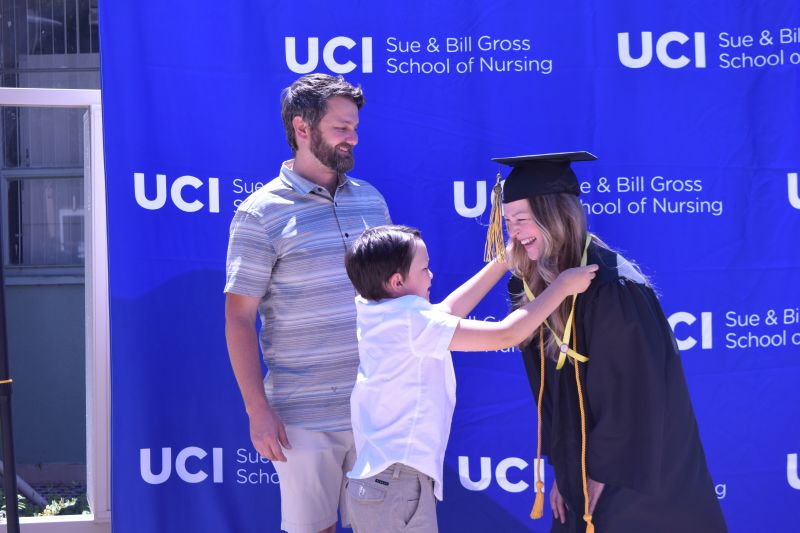 uc irvine school of nursing class of 2021 graduate commencement miranda apalategui and her son and husband at pinning ceremony