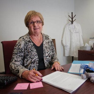nurses week spotlight on uc irvine school of nursing founder ellen lewis at a desk with papers