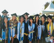 2024 Graduates of the UC Irvine School of Nursing standing outside in regalia.