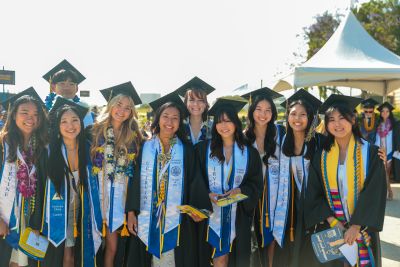 2024 Graduates of the UC Irvine School of Nursing standing outside in regalia.